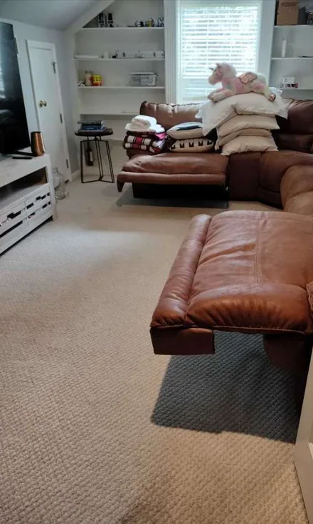 The same living room with the carpet clear and the couch straightened