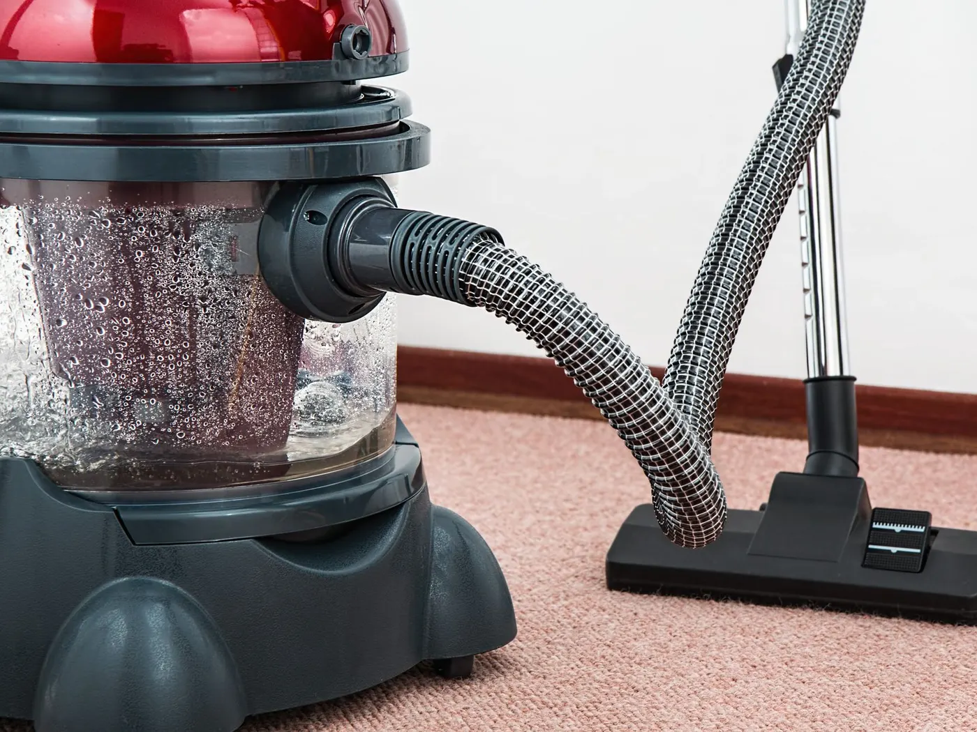 Stock photo of a water-filtration vacuum cleaner on a pink carpet
